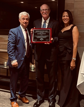 Brad Blower and Obrea Poindexter present Mike Calhoun with the 2023 Lifetime Achievement Award on April 29, 2023.