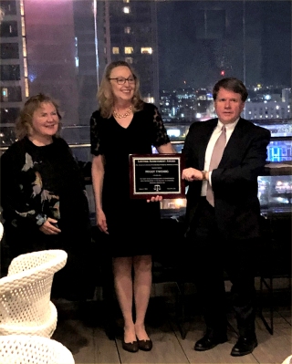 Jean Noonan and Andrew Smith present Peggy Twohig with the 2022 Lifetime Achievement Award on April 2, 2022.